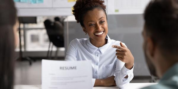 Woman in an interview answering questions and feeling positive about the outcome.