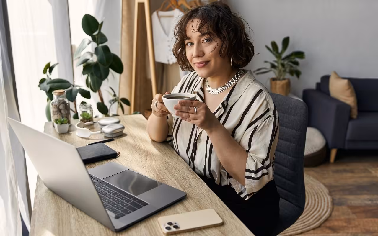 A peaceful remote workspace showing an introvert comfortably working from home with a laptop and coffee.