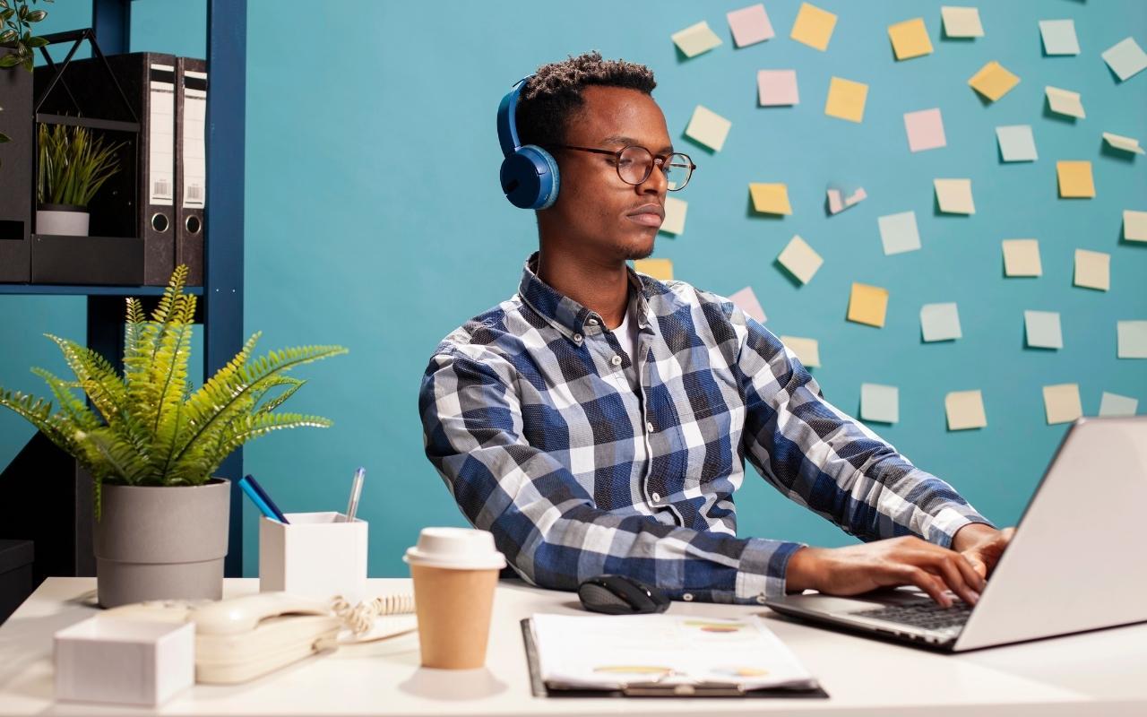 Learning Disability Office Worker Wearing Headphones