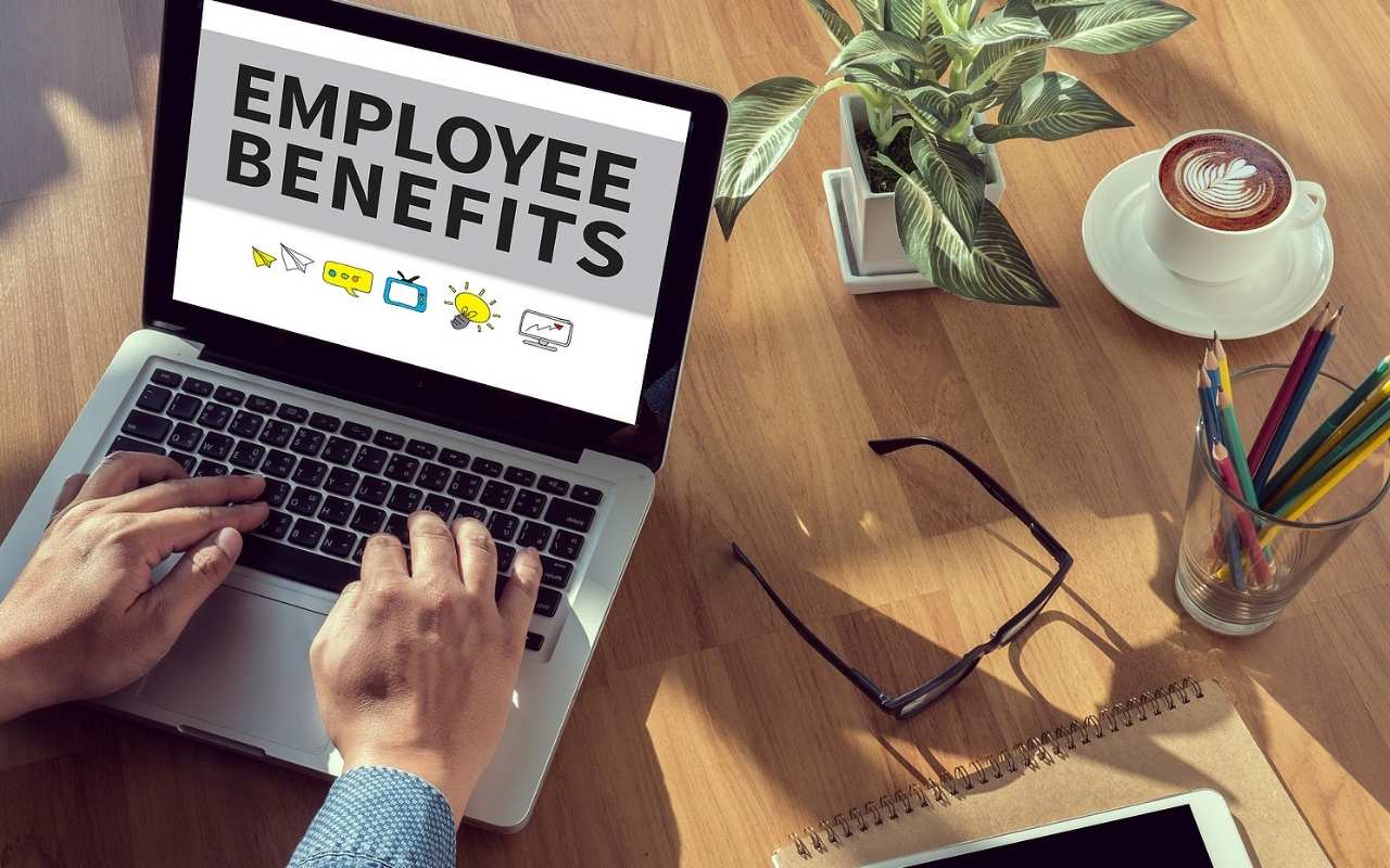 Worker Managing Employee Benefits On Laptop