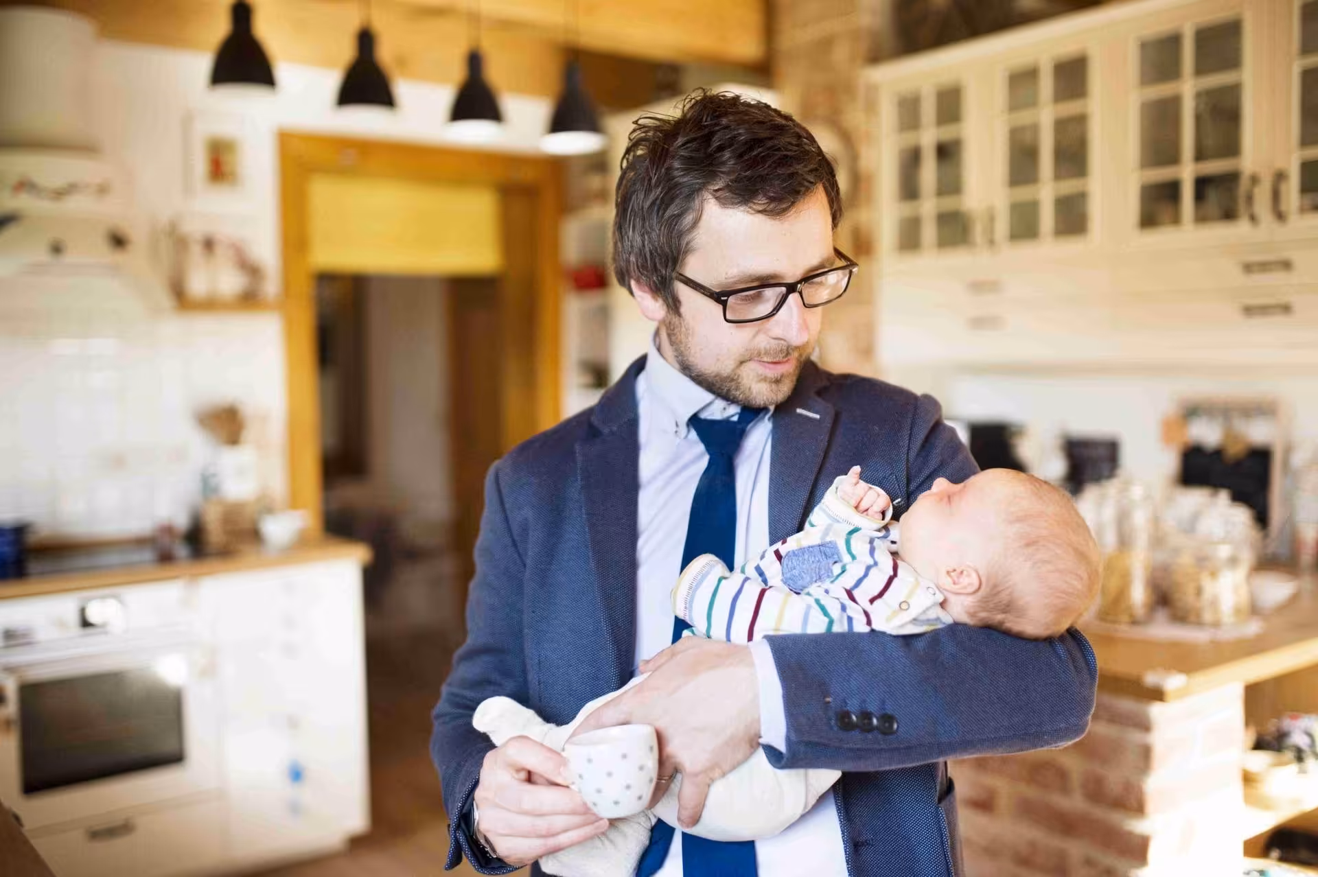 father-holding-baby-parental-leave-return